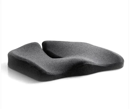 Dark gray memory foam coccyx seat cushion with U-shaped tailbone cut-out, angled front view