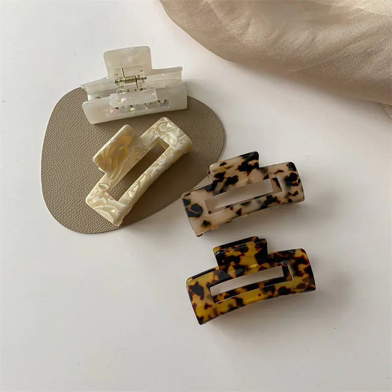 Acetate claw clip showing its sprung metal hinge and glossy finish