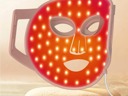 LED face mask lit in red light therapy mode showing the full-face LED array