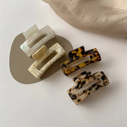Group of large rectangular acetate claw clips in assorted finishes