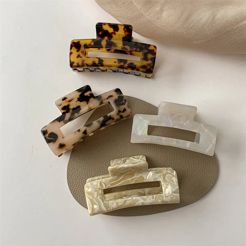 Large acetate claw clips in tortoise, light tortoise and pearl white finishes