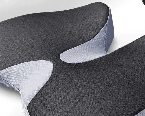 Top view of the car seat cushion showing the breathable black diamond-mesh cover, contoured grey side wings, and the raised coccyx-relief channel.